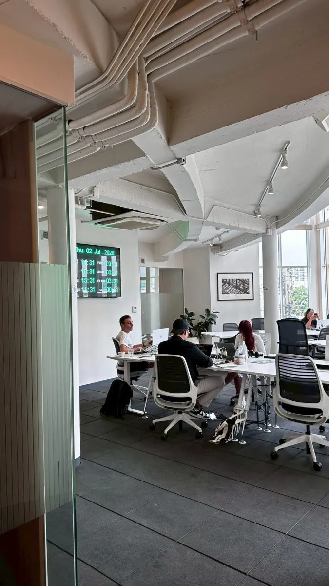 Members working beneath the world-clock display