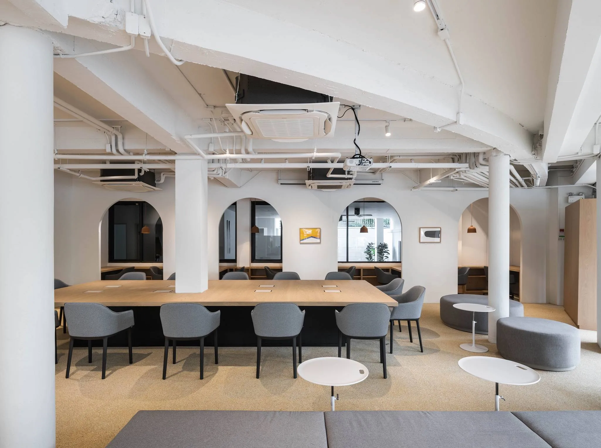 Shared desk space at Atlas Workspace with natural light